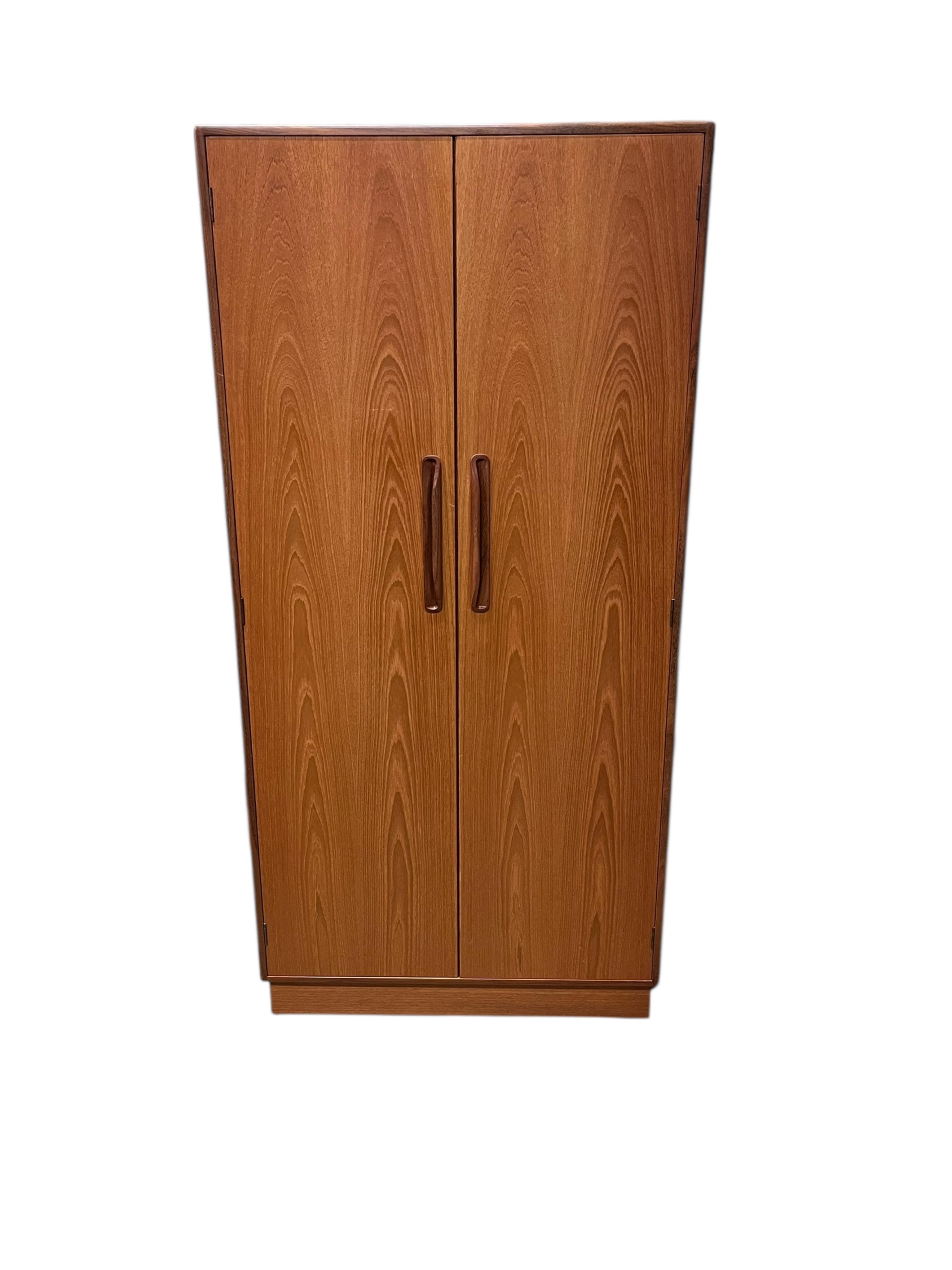 A mid century G Plan Fresco teak bedroom suite comprising a three door wardrobe, a two door wardrobe, two six drawer chests, dressing table, headboard and a pair of bedside chests